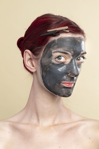 Black charcoal mask on a woman's face