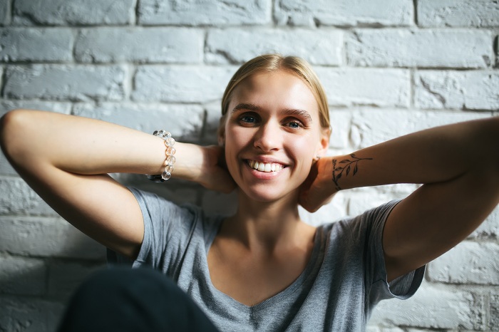 Happy woman with tattoo on her wrist