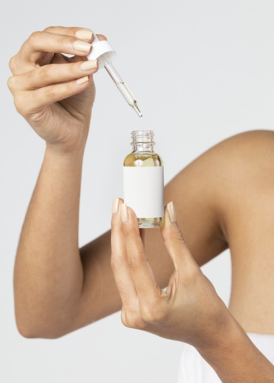 Woman using a serum for skincare