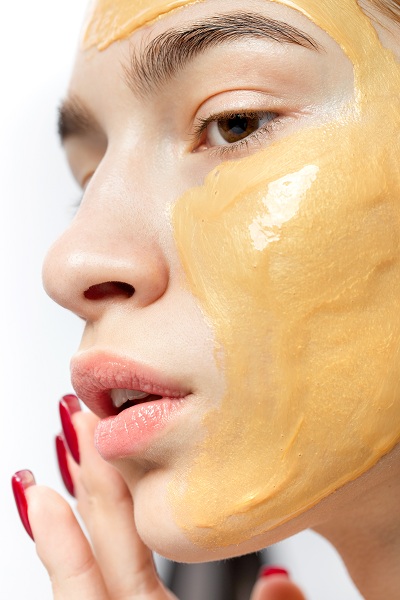 Woman's face with turmeric facial mask