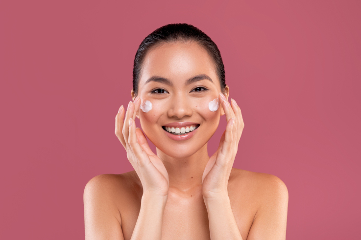 happy asian lady with face cream