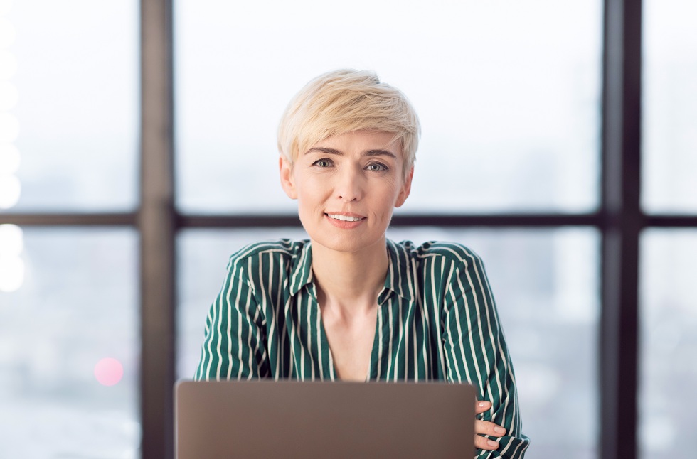 Mature Business Lady Sitting At Laptop In Modern Office