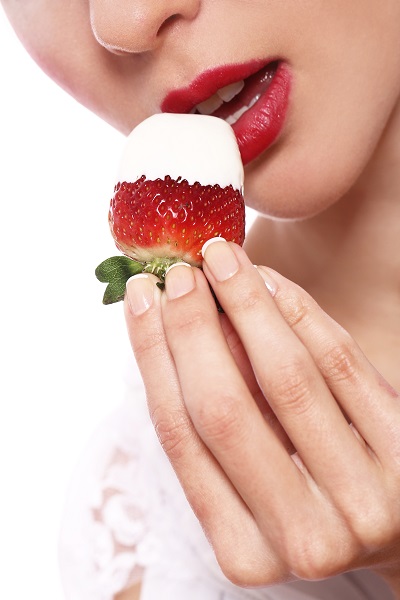 Woman lips and a strawberry