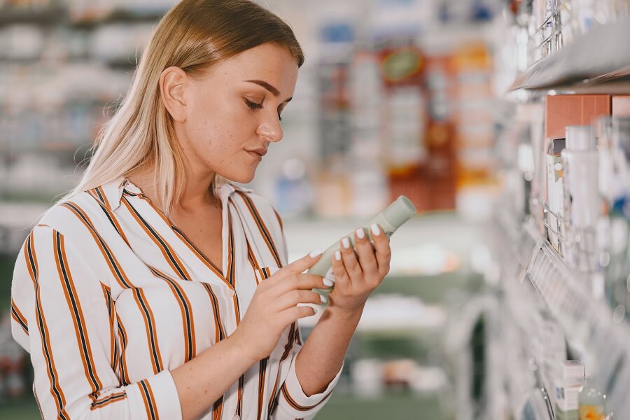 woman trying to buy skincare products from a pharmacy