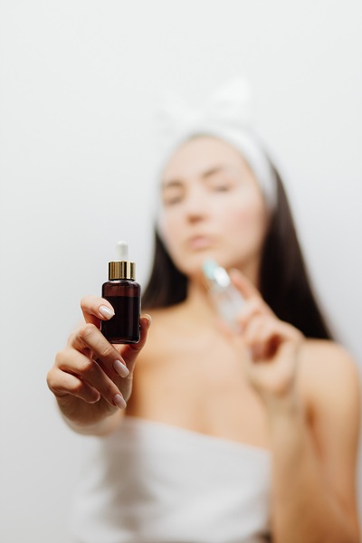 woman using face serum as skin care routine